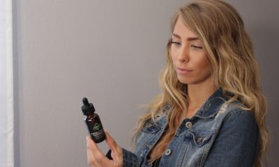 This picture show a person looking at a CBD oil.
