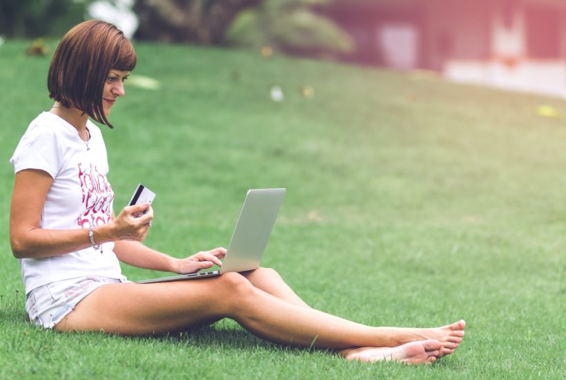 This picture show a teen checking a laptop.