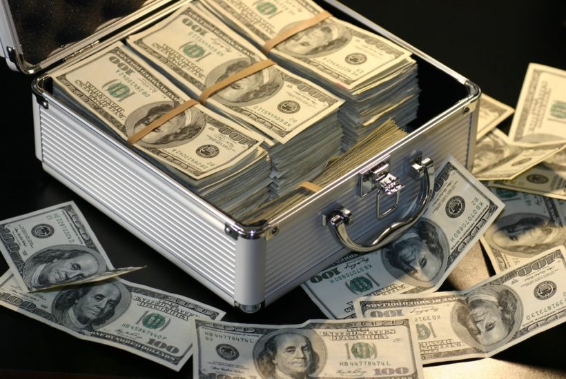 This picture show a case full of dollar bills.