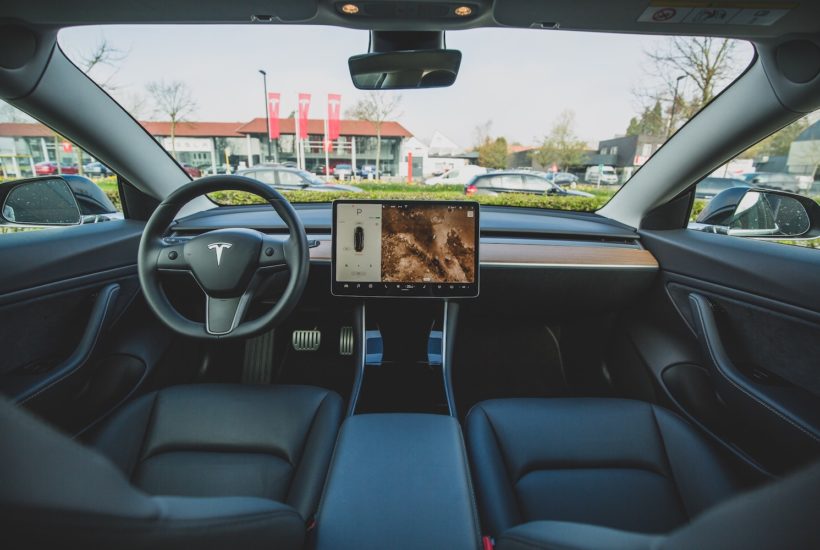 This picture show the cabin of a Tesla car.