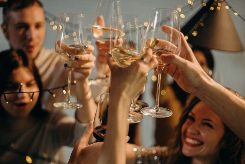 This picture show a group of people celebrating and drinking wine.