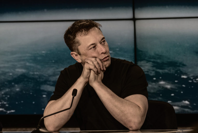 Elon Musk contemplative, perhaps considering gold and silver curency?