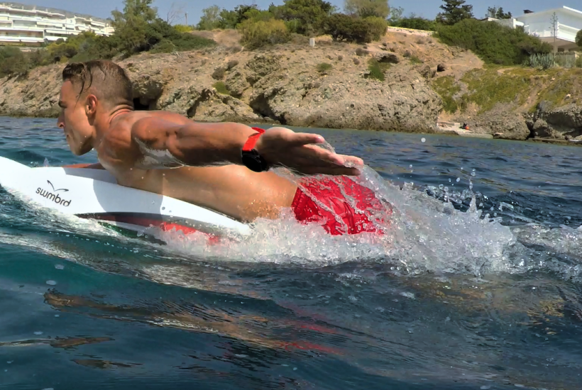 A man paddling a SWMBRD