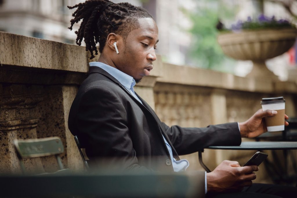 Young man browsing a top restaurant app from Restaurant.com