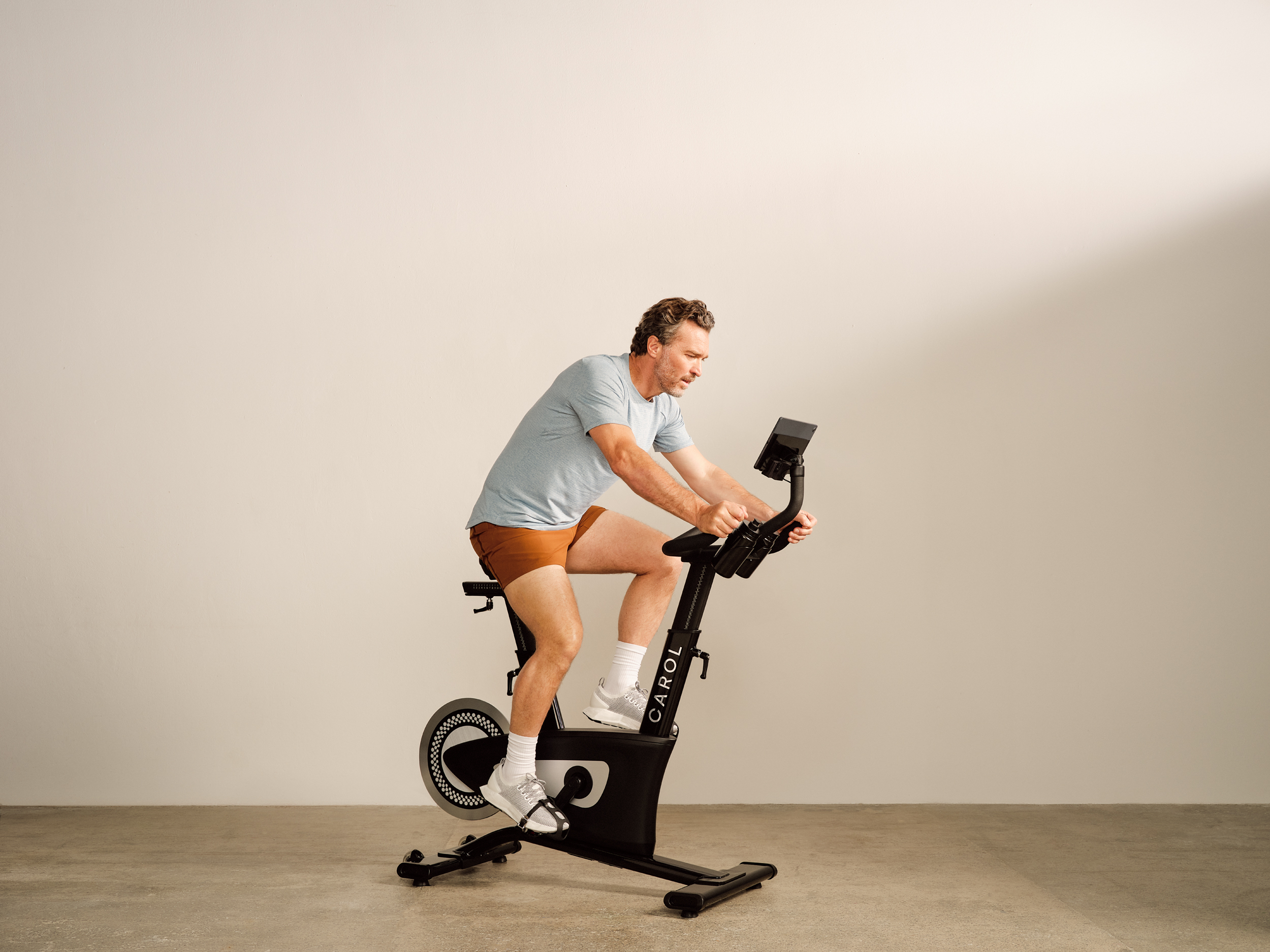 Man following an AI-powered workout with CAROL Bike