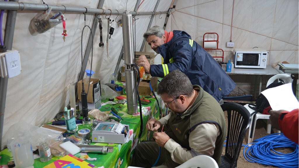 Geologists prepare a small submersible pump for a well test at the Argentina Lithium Rincon West project.